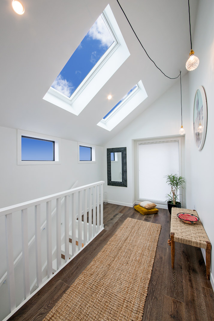 skylight with blue skies above stairs with lights in wellington